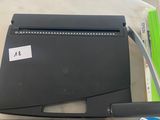 a table that has various items on it including scissors, a ruler, and a paper cutter