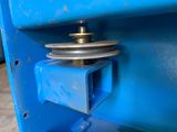 a close up of a blue machine with a metal pull