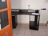 an image of a corner desk in the corner of a room