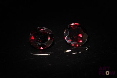 a pair of red diamonds on a black surface