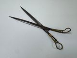 a pair of scissors sitting on a white surface