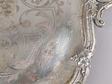 a silver tray with a design on it on a table