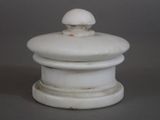a white container with a white lid on a gray surface