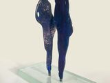 sculpture of a couple holding hands on a glass plate