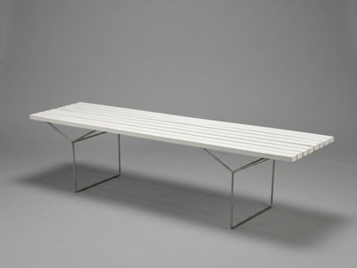 an image of a white bench sitting on top of a gray floor