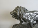 a statue of a lion standing on a rock