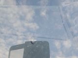 a reflection of a man in the back seat of a car
