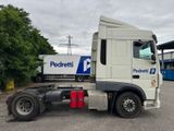 a semi truck parked in a parking lot with other semi trucks in the background