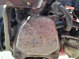 a close up of a motorcycle engine with a chain attached to it