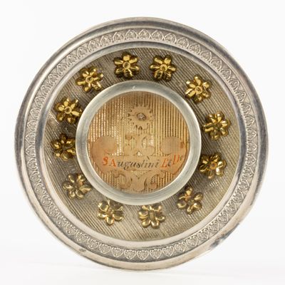 a silver plate with a coin in the middle of it