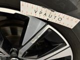 a close up of a car wheel with a measuring tape on it