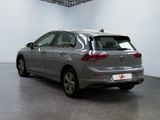 the back of a silver car in a white room