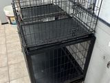 two cages that are sitting on the floor in the room