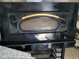 a black oven sitting in a kitchen next to a counter