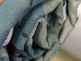 a close up view of a folded towel on a bed
