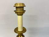 a gold candle that is on a white table