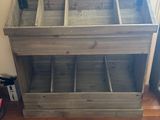 a picture of a wooden storage unit in the corner of a room