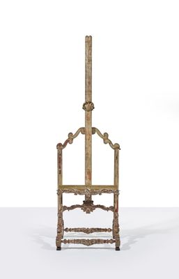 an old wooden easer with a wooden top and a metal stand