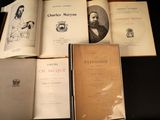 several books are sitting on a table with a black background