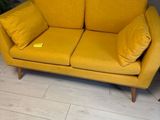 a yellow couch that is sitting on the floor