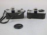 two cameras sitting next to each other on a table