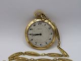 an image of a gold pocket watch with a chain around it