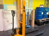 a fork lift in a warehouse with pallets in the background