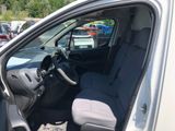 the interior of a car with the door open and the driver ' s seat down