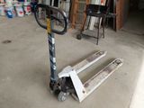 a pallet that is sitting on the ground in front of a garage