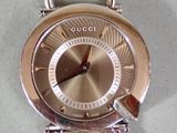 a close up of a watch on a white surface