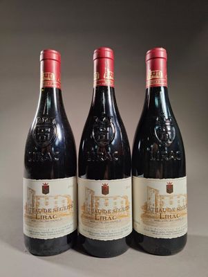 trois bouteilles de vin rouge posées sur une table