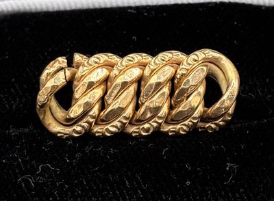 an image of a close up of a gold bracelet on a black surface