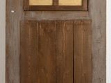 a wooden door with a glass window in it