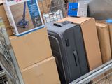 many pieces of luggage sitting in a cart in the store