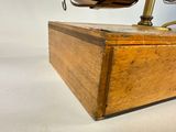 a wooden box with a clock on top of it