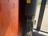 a water dispenser in front of a brick wall