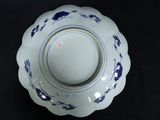 a blue and white bowl on a black table