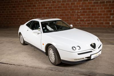a picture of a white car parked in a parking lot