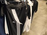 clothing hanging on a rack in a clothing store in a store