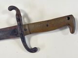 a very old knife that is hanging on the wall