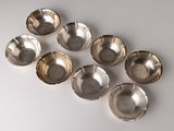 six silver plated bowls on a white surface with a white background