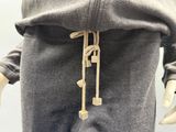 the back of a mannequin wearing a grey sweatshirt and pants