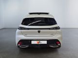 the rear end of a white car in a white room
