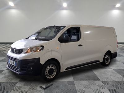la camionnette blanche est garée dans une grande pièce au sol en damier