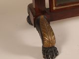 a gold shoe that is sitting on a table