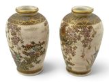 pair of asian vases with flowers and birds on them on a white background