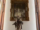 a statue of a woman holding a child in a room