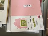 a lot of folders that are sitting on a bed