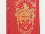un livre rouge posé sur une table blanche