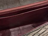 a close up of a black purse with a gold clasp